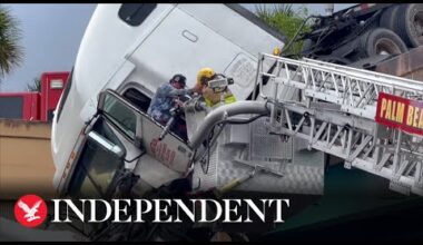 Moment driver rescued from dangling truck over busy highway