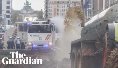 Belgian farmers spray manure towards police who respond with water cannon