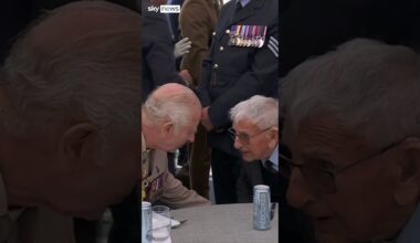 King Charles holds veteran’s hand