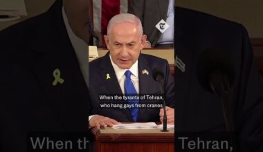 Democrat representative holds 'war criminal' sign at Netanyahu address