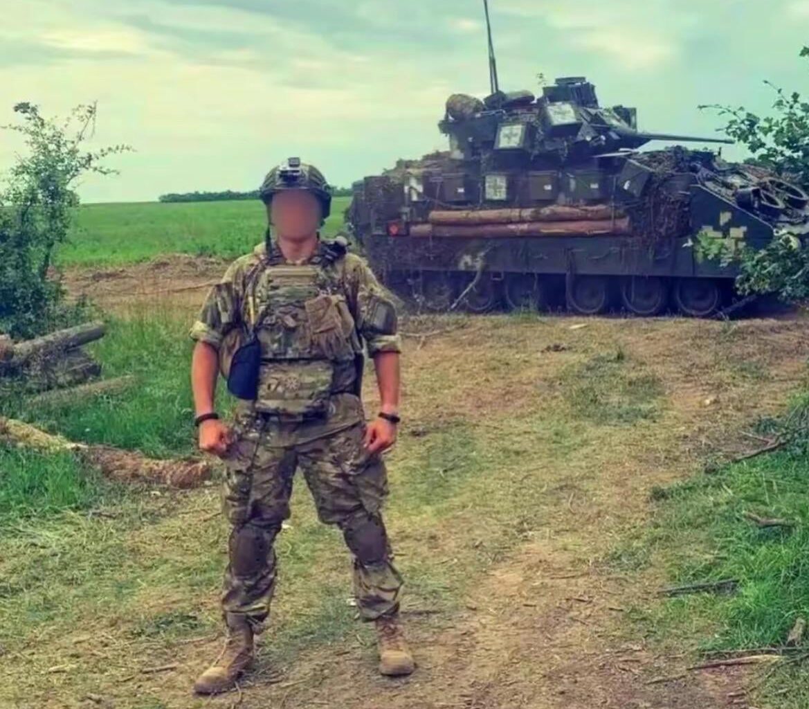 Ukrainian soldier posing next to a Bradley IFV, June 2024