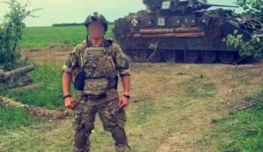 Ukrainian soldier posing next to a Bradley IFV, June 2024