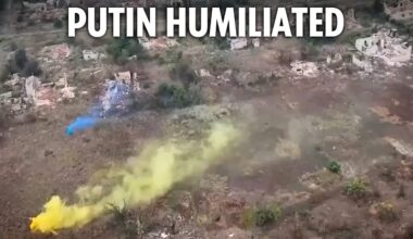 Ukrainian troops raise their flag after taking land back from Russians in blitz