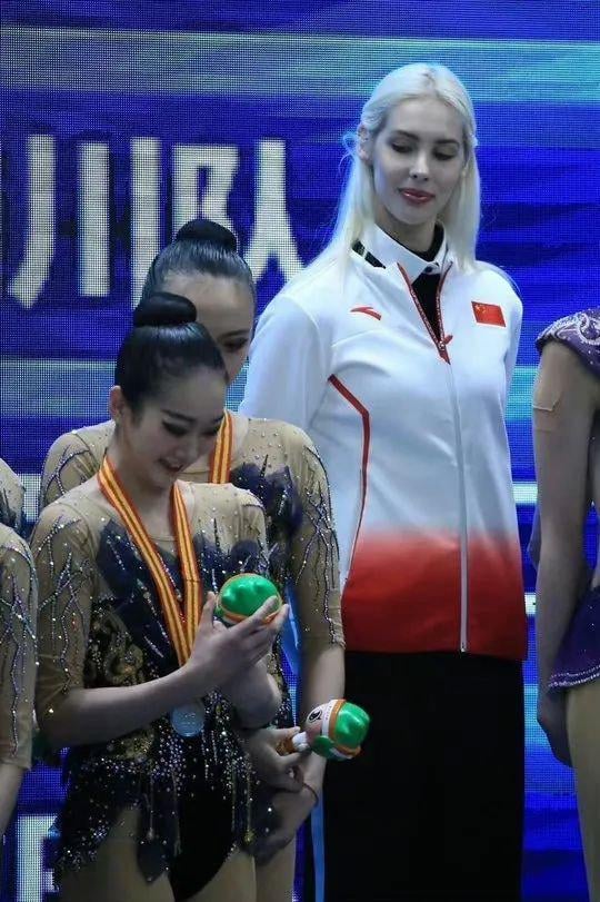 She is Russian's Olympic champion Anastasia Bliznyuk. After Russia got banned, she coaches the Chinese artistic gymnastics team and help them to win gold medal for the first time.