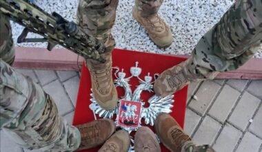 Ukrainian troops stand on the coat of arms of the Russian Federation in the Kursk region - August 2024