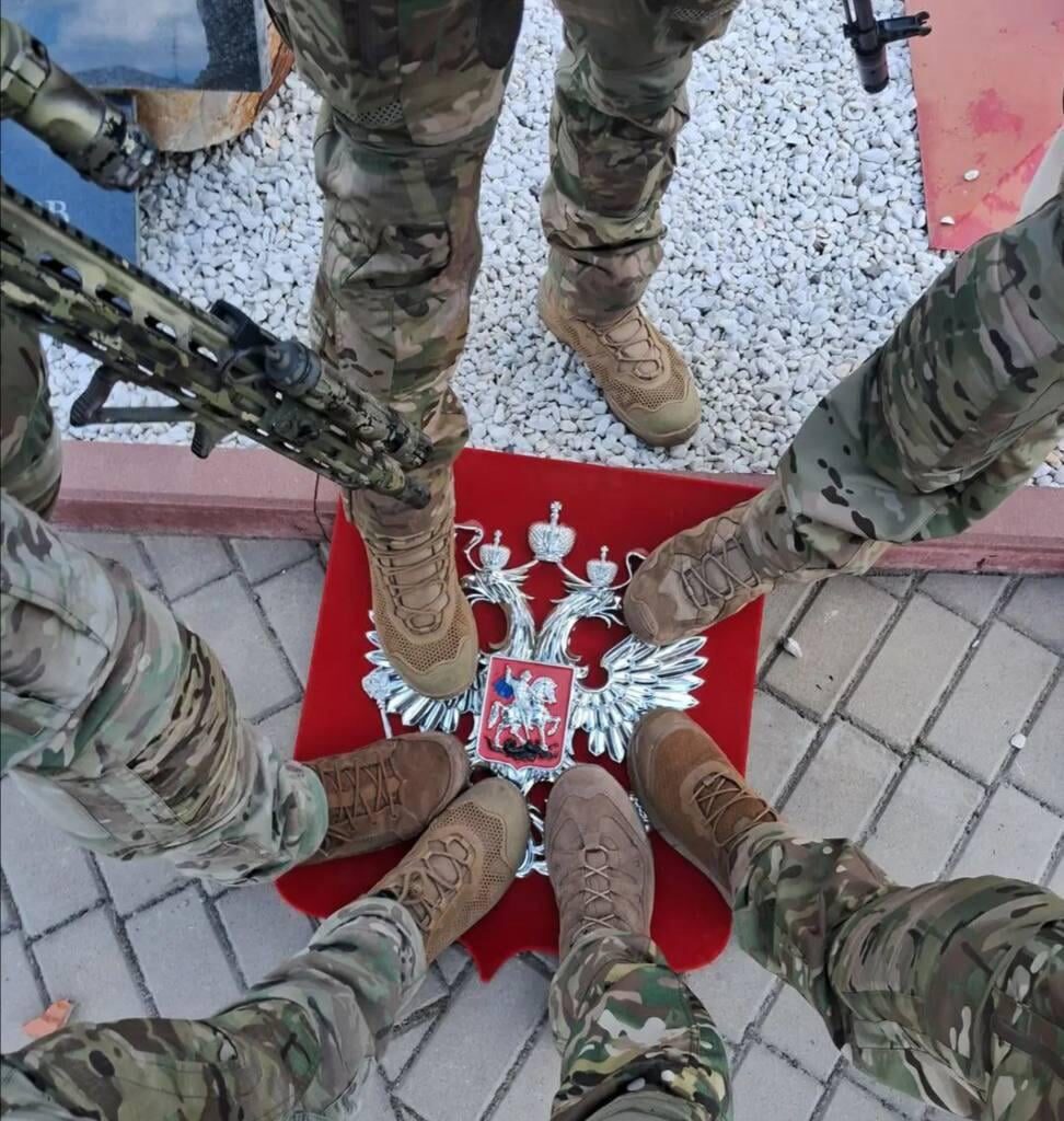 Ukrainian troops stand on the coat of arms of the Russian Federation in the Kursk region - August 2024