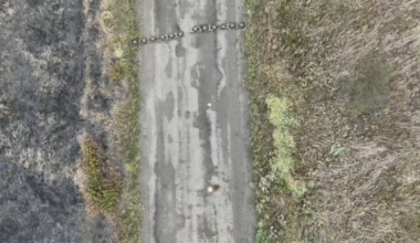 A Ukrainian drone operator uses an explosive charge hanging from his drone to clear a Russian mine barrier.