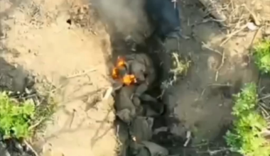 Russian soldiers try to extinguish a fire