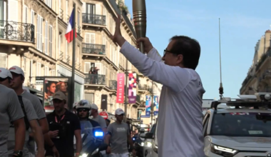 Jackie Chan carrying the Paralympic torch through Paris