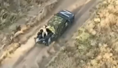 A Russian is dumping comrade's dead bodies from the truck to help it outrun the chasing drone.