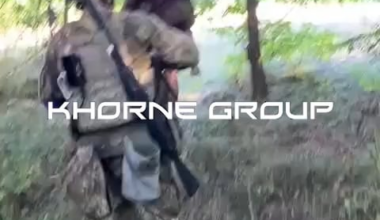 Ukranian soldier from Khorne group carrying wounded russian soldier on his back somewhere in Kursk region (don't ask about yellow tactical shorts)