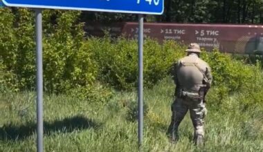 Soldier from the Ukrainian Army, 'relieving himself' at a road sign with has Moscow (740), afterwards he wipes his hands on the sign.