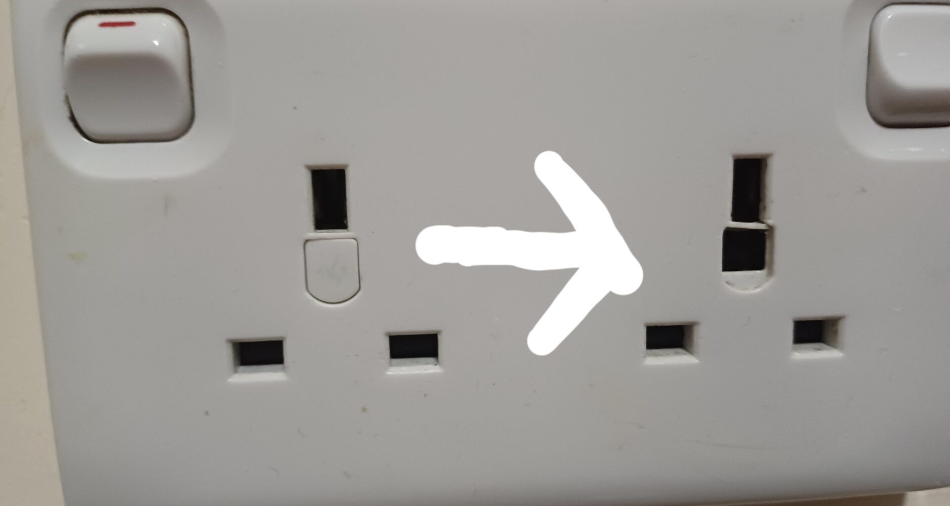 Plug socket started crackling and a hole appeared. I instantly switched it off after leaving a charger in there (for a few days) What should I do?