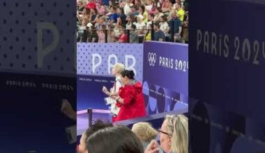 Rhythmic gymnastics coaches Sun Dan and Anastasia Bliznyuk reacting to their team's finals performance