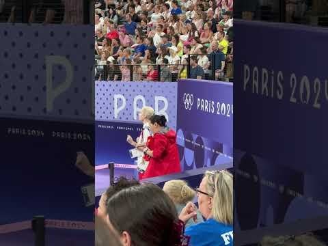 Rhythmic gymnastics coaches Sun Dan and Anastasia Bliznyuk reacting to their team's finals performance