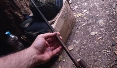 Ukrainian Army soldier holds an old bayonet from a Russian Mosin-Nagant bolt-action rifle: recently dug up in a trench in eastern Ukraine.