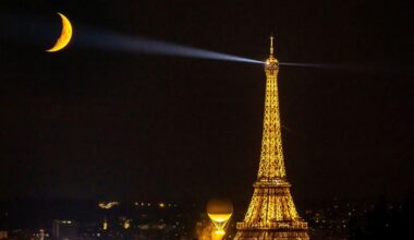 Eiffel and the Moon swap shines as the Olympic flame joins the glow fest. (A photo by Christian Hartmann for Reuters, taken on August 9)