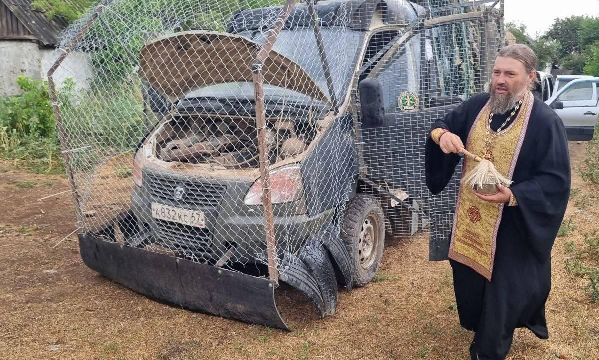 Russian van with cope cage + priest blessing for drone protection