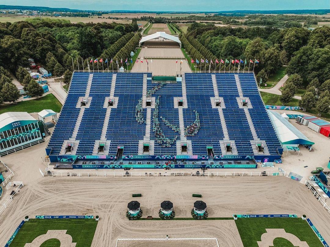 Volunteers assembled in the shape of the Agitos in the Versailles stands