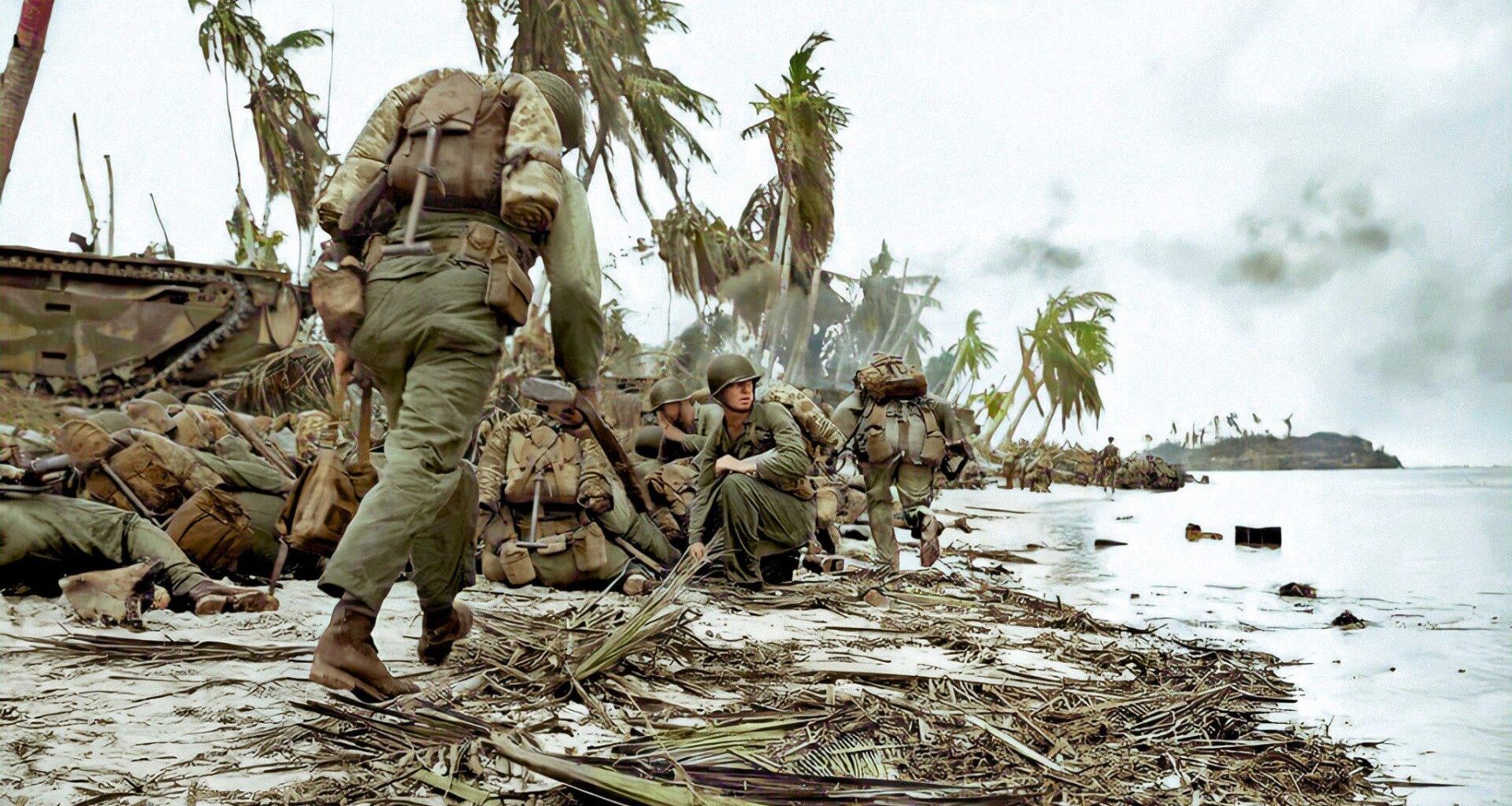 July 20, 1944.
Assault troops with the III Amphibious Corps, composed of the 3rd US Marine Division and the 1st Marine Provisional Brigade leap from their amphibious tractors for the shelter of the sand dunes, during the assault on Guam.