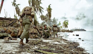 July 20, 1944.
Assault troops with the III Amphibious Corps, composed of the 3rd US Marine Division and the 1st Marine Provisional Brigade leap from their amphibious tractors for the shelter of the sand dunes, during the assault on Guam.