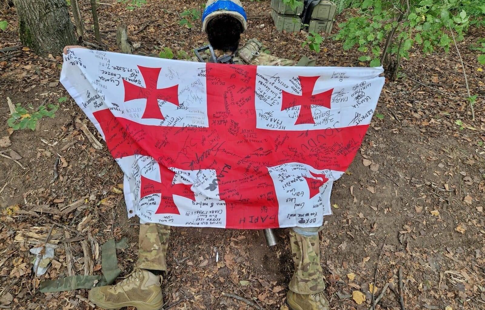 August 7th, 2024 (16 years since the Russian invasion of Georgia) – a soldier from the Ukrainian Army holds up a Georgian flag - during the recent advances into the Kursk region.