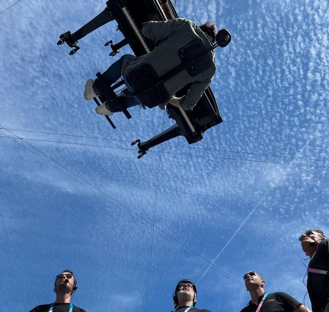 Behind the scenes photos from Alain Roche's vertical piano performance at the closing ceremony