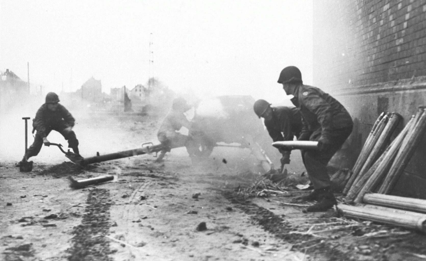 Troops of the 35th Division 9th U.S. Army turn a German Pak 40 75mm anti-tank gun against its former owners along the Rhine-Herne Canal near Recklinghausen in April 1945