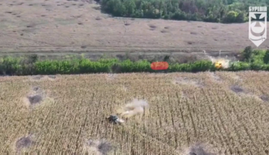 Ukrainian T-64 tank of the 1st Presidential Operational Brigade, equipped with anti-drone protection, fires at a tree line where Russian troops were spotted trying to advance using the cover of the dense vegetation.