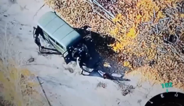 Russian soldiers drag a dead russian into their UAZ-452 "Bukhanka".