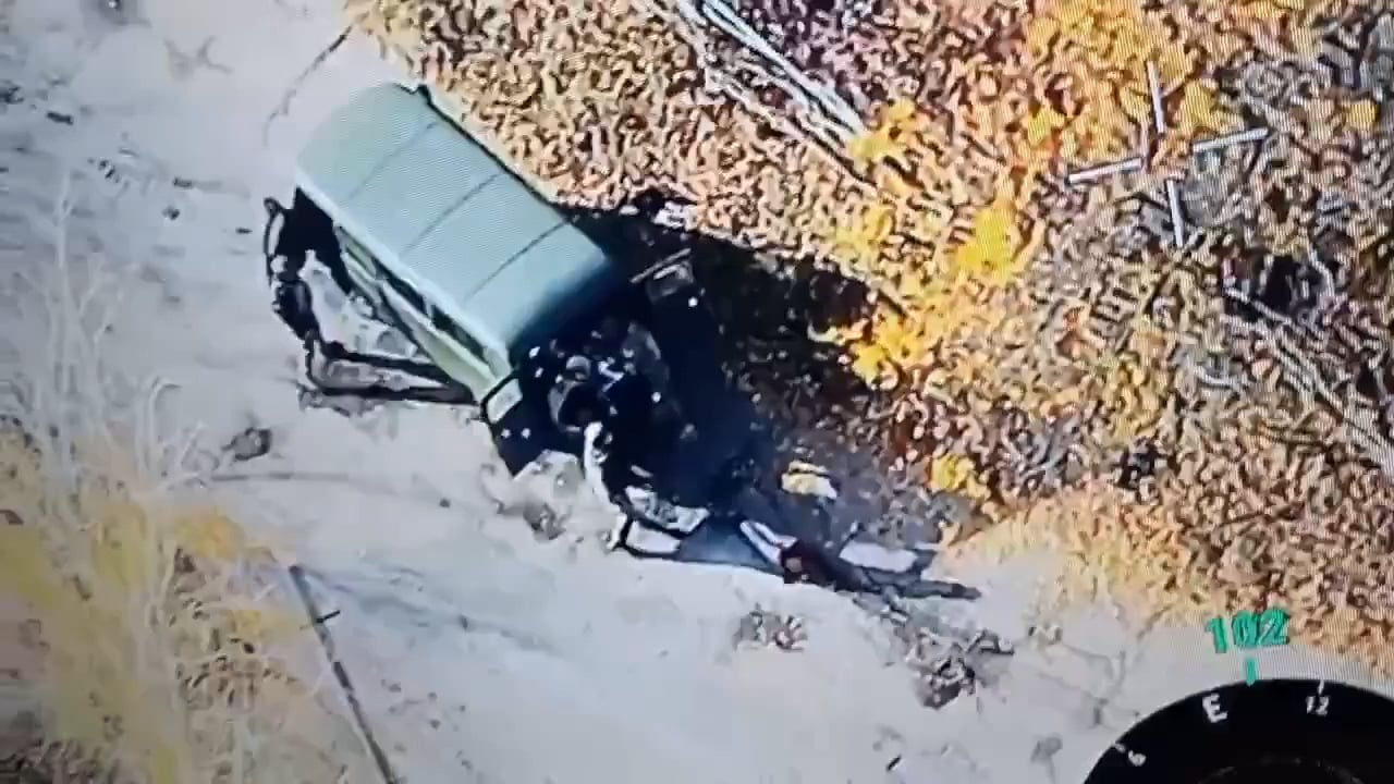 Russian soldiers drag a dead russian into their UAZ-452 "Bukhanka".