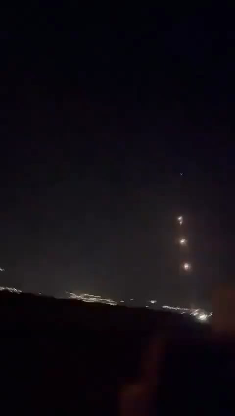 Missile barrage from Lebanon + Iron Dome interceptor launch captured in the same clip