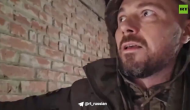 Russian RT reporter/combatant films himself hiding in a factory in Donbas when an FPV drone enters the building. The drone explodes inside the factory but fails to cause casualties. September 2024