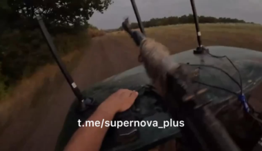 GoPro view of Russian soldier in back of speeding tactical golf cart firing rifle at pursuing FPV drone (which nearly hits them)