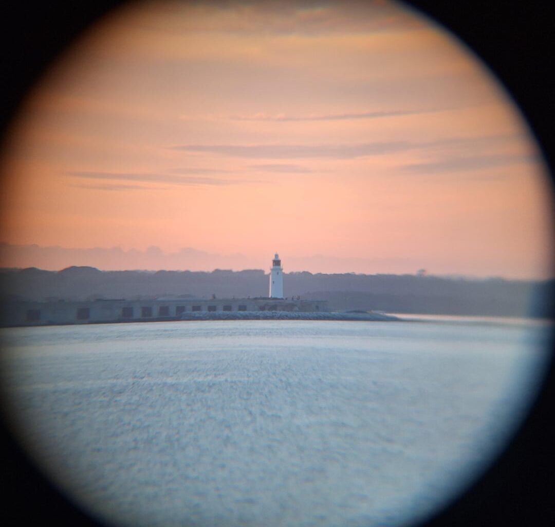 Couple photos I took of Hurst Castle through a pair of binoculars.