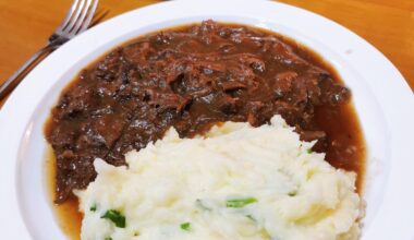 Slow cooked pork cheeks ragout with creamy scallions mashed potatoes and sautéed Chinese cauliflower on the side