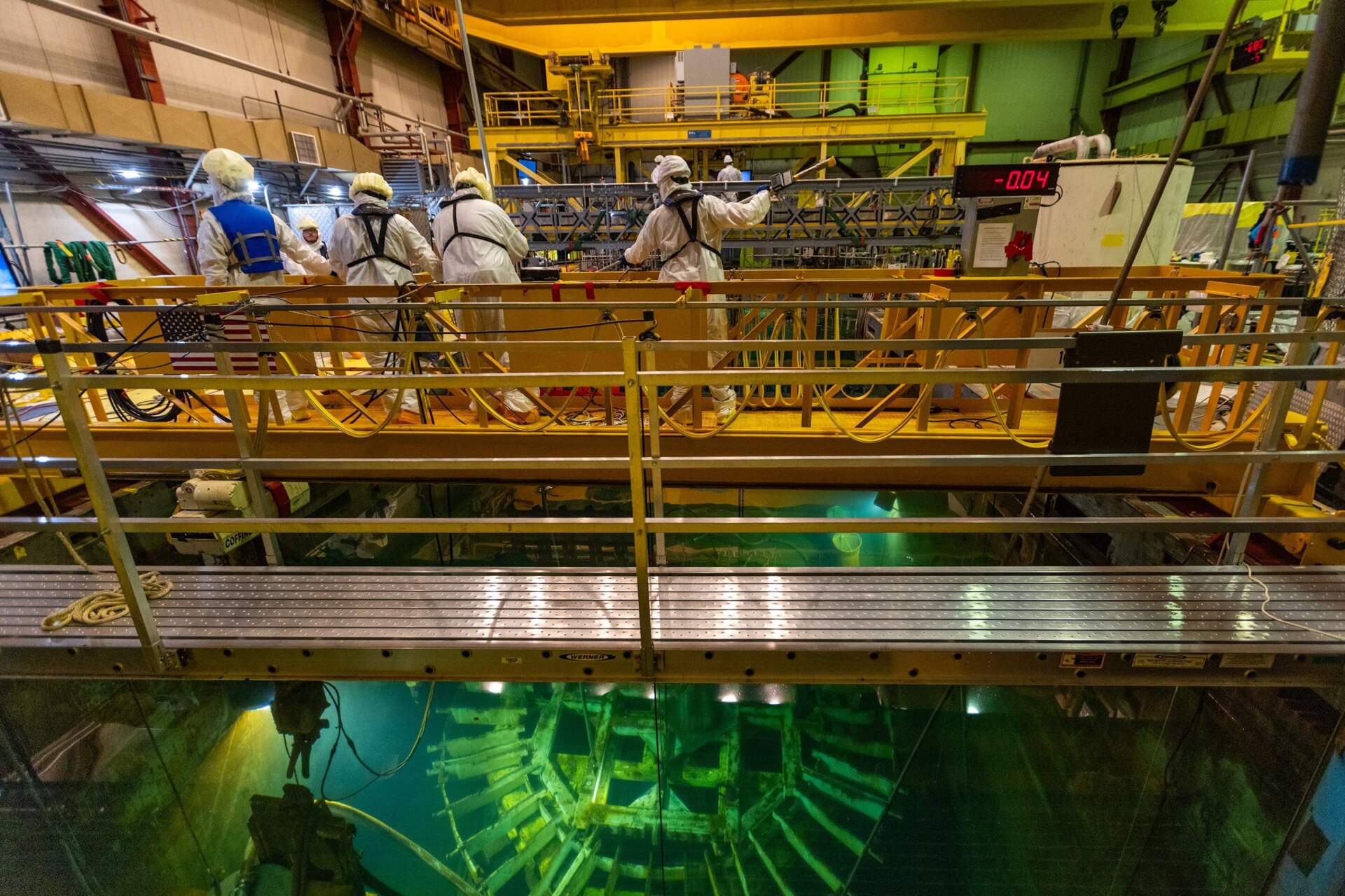 A decommissioning crew works in the dryer separator pit filled with filtered wastewater in the Pilgrim Nuclear Power Station reactor. (Jesse Costa/WBUR)