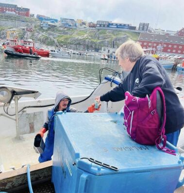 Handing coffee to a local fisherman