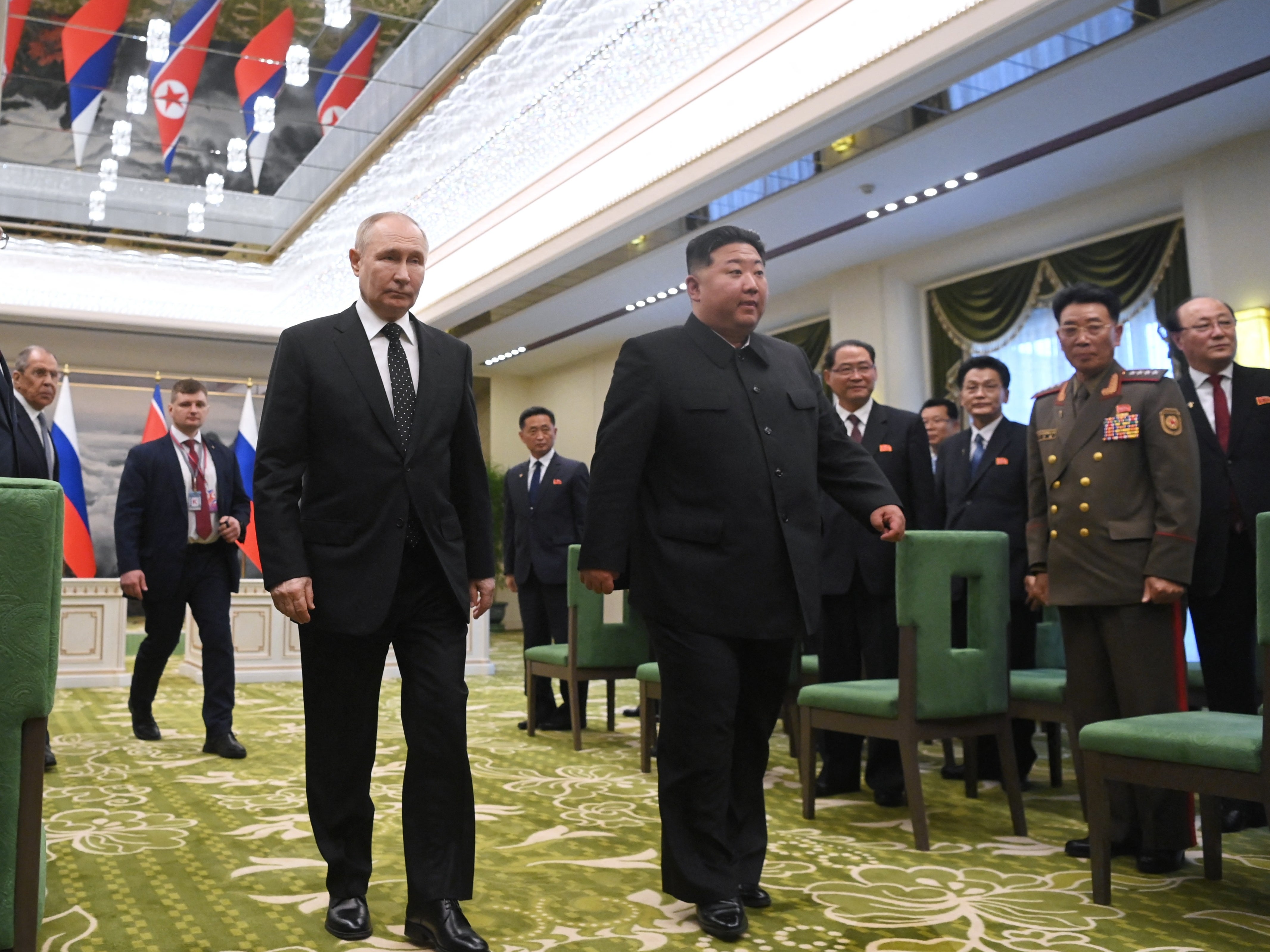 Russian President Vladimir Putin and North Korean leader Kim Jong-un walk in Pyongyang on 19 June 2024