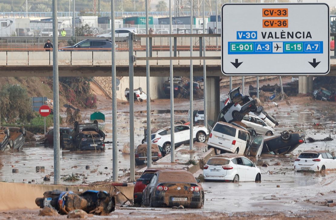 Damaged cars are seen along a road affected by torrential rains on the outskirts of Valencia on Thursday. 