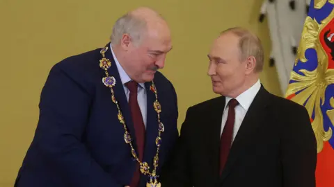 EPA Alexander Lukashenko and Vladimir Putin shake hands 