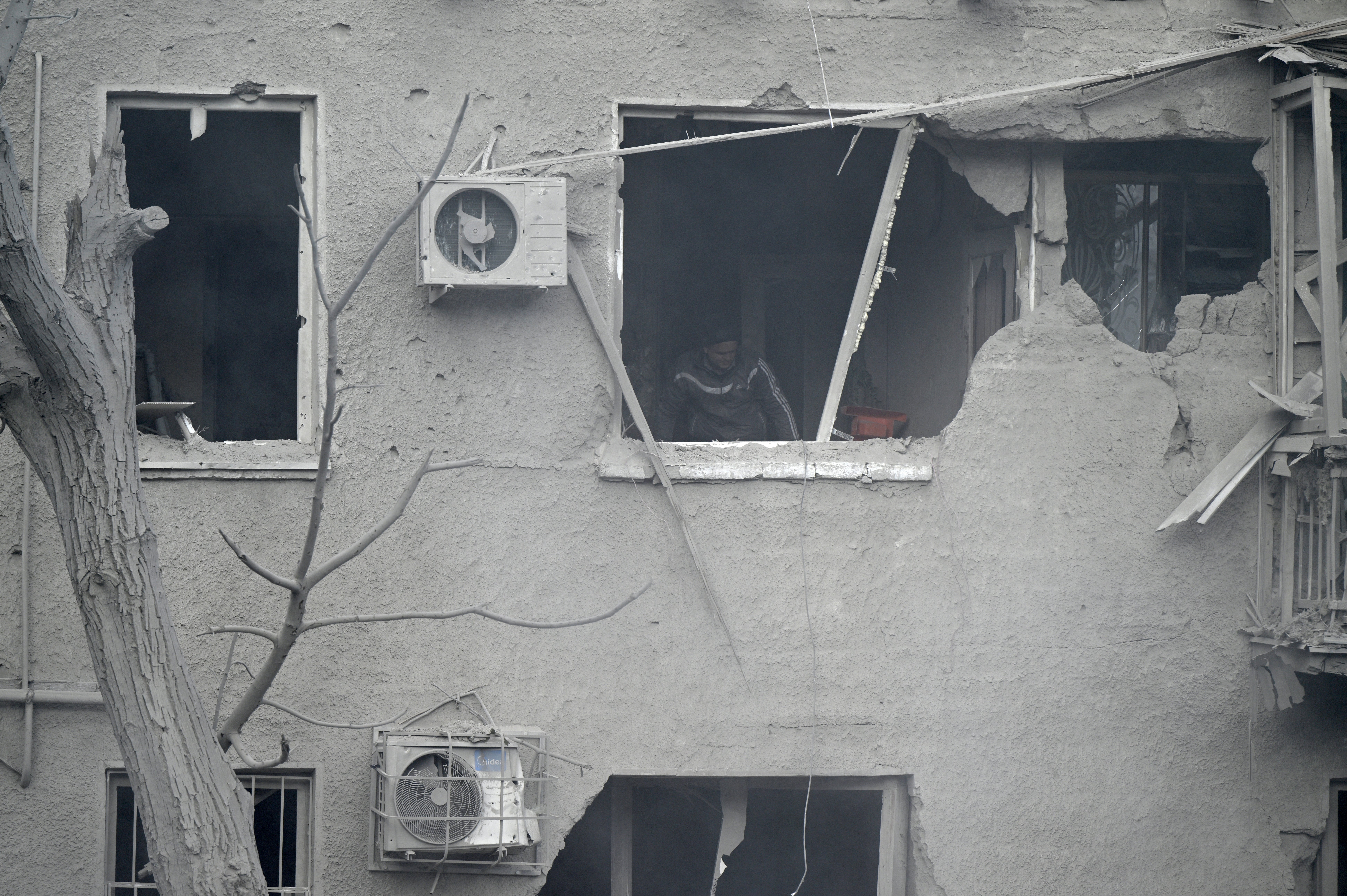 A man is seen in a heavily damaged apartment following a Russian missile strike in Dnipro, eastern Ukraine, on 26 October 2024