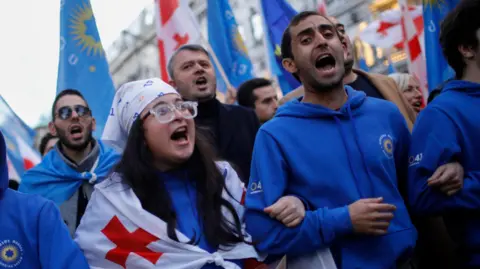 EPA-EFE/REX/Shutterstock These young Georgian Dream supporters take part in a final campaign rally on 23 Oct