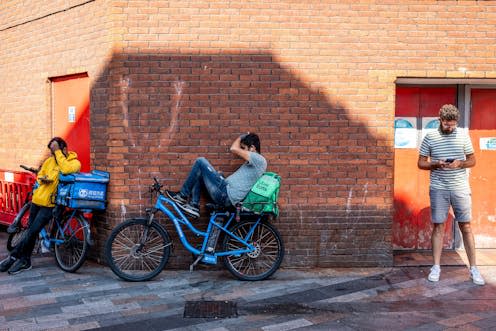 <span class="caption">Gig economy workers take a break in Chinatow, London. </span> <span class="attribution"><span class="source">Shutterstock/Grant Rooney</span></span>