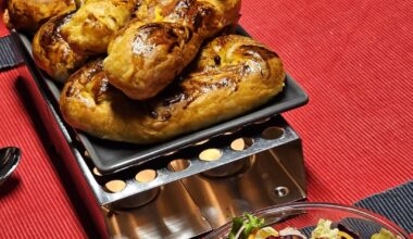 Homemade sausage rolls made from puff pastry and original Emmental cheese sausages ("orig. Emmentaler Käsewürstli") with a cheese and tomato filling (the cheeses were savoury Appenzeller and Gruyère), along a salad with pomegranate seeds