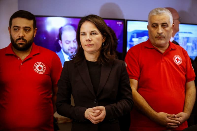 German Foreign Minister Annalena Baerbock is briefed on the safety, security and strategic management during her visit to the Red Cross Crisis Response Center in Hazmieh, southeast of Beirut. Marwan Naamani/dpa