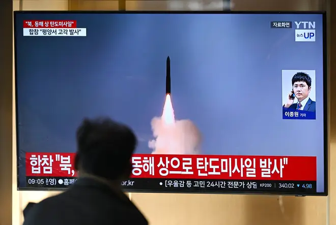 News broadcast with file footage of a North Korean missile test