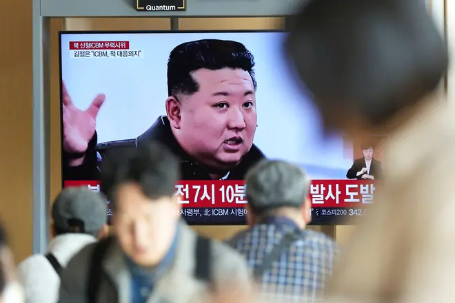 A TV screen shows an image of North Korean leader Kim Jong Un