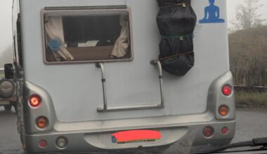 Why is this caravan transporting a body on the back of it?