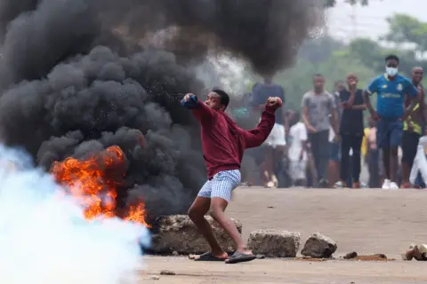 Reuters A young man throws a stone during a nationwide protest called by presidential candidate Venâncio Mondlane in Maputo, Mozambique - Monday 21 October 2024